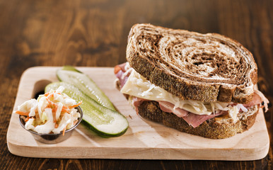 reuben sandwich with kosher dill pickle and coleslaw