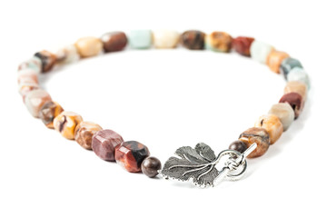 Handmade necklace with brown gemstone beads on white background