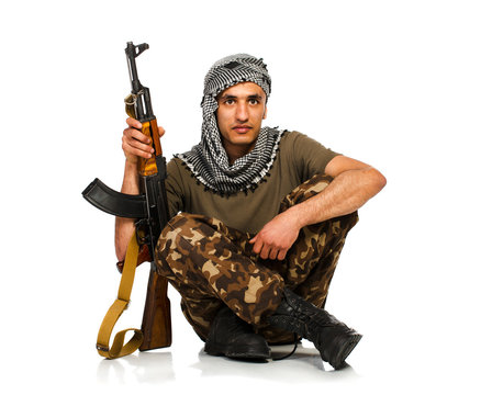 Terrorist with automatic gun on white background