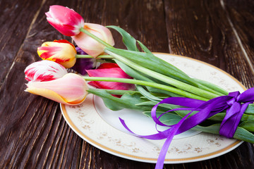 armful of tulips on a plate