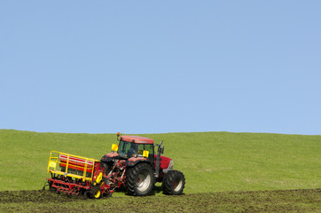 Naklejka premium Tractor plowing the ground