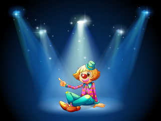 A stage with a female clown sitting at the center