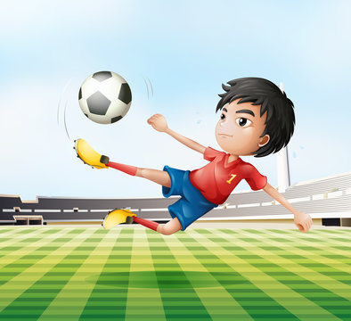 A boy playing soccer in the soccer field