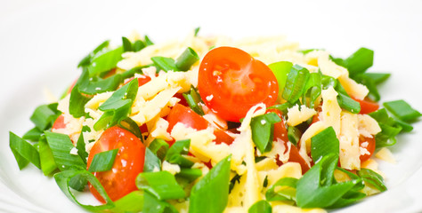 Fresh vegetable salad with cherry tomatoes, green onions, cheese