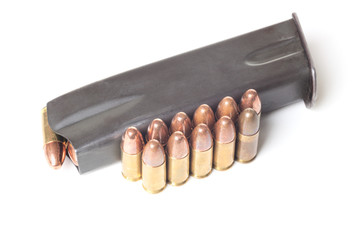 Two rows of 9mm brass bullets and gun holder