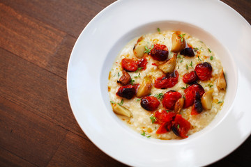 Creamy risotto with roasted cherry tomatoes and garlic