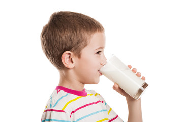 Smiling child boy drinking milk