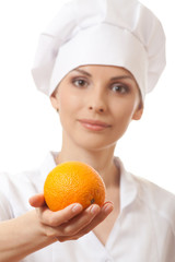 Smiling woman cook with orange, isoladed on white background