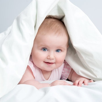 cute baby under a blanket