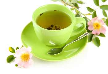 Cup of herbal tea with hip rose flowers, isolated on white