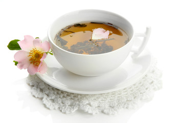 Cup of herbal tea with hip rose flowers, isolated on white