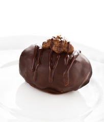 Close up of one large dark chocolate ball on white background
