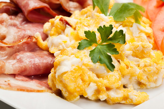 Closeup of scrambled eggs with bacon. Selective focus.