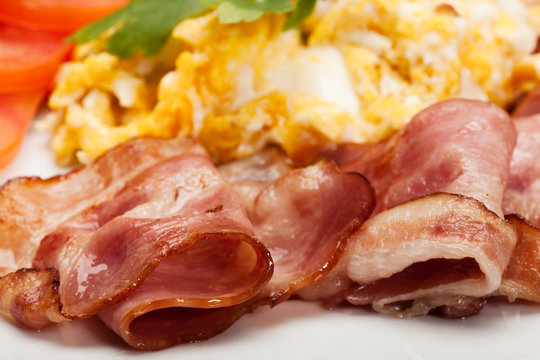 Closeup of scrambled eggs with bacon. Selective focus.