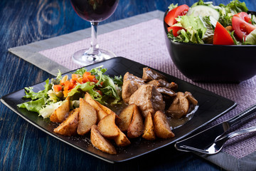 Goulash with prepared potatoes. Dark tone