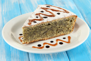 Delicious poppy seed cake on table close-up
