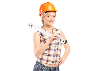 Smiling female worker with helmet holding a construction bubble