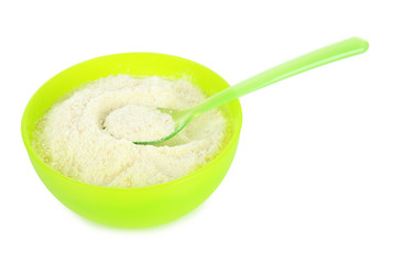 Powdered milk in bowl and spoon for baby isolated on white