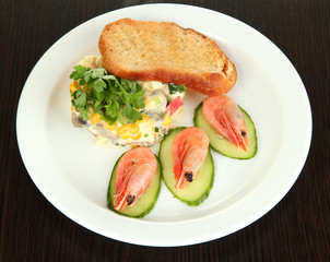 Small portion of food on big plate on wooden table