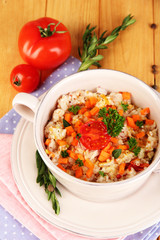 Delicious rice with vegetables and herbs in pot
