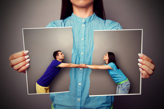 Girl Holding The Torn Photo Of Couple