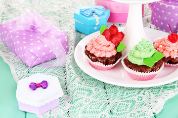 Delicious beautiful  cupcakes on festive table close-up