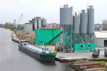 Ship in harbor of the cement plant. Netherlands