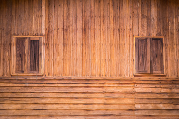 Wooden wall of ancient house with window closed.