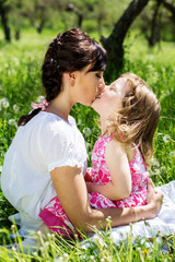 Fototapeta premium Little girl and mother resting on the nature