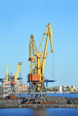 Fototapeta na wymiar Port cargo crane over blue sky background