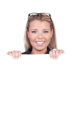 Cheerful woman holding up a blank sign