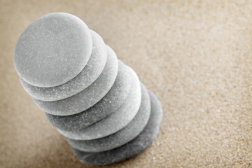 Fototapeta na wymiar The group of stones lies on small sea sand