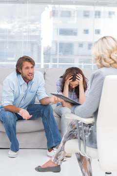 Therapist listening to the couple sit on the couch
