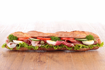 sandwich with ham,lettuce,cucumber and tomato