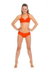 Fototapeta premium Full length portrait of happy young woman in swimsuit