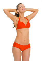 Fototapeta premium Happy young woman in swimsuit enjoying sunbathing