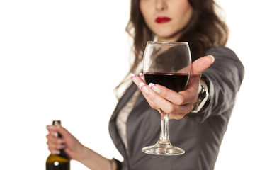 woman offering a glass of red wine with