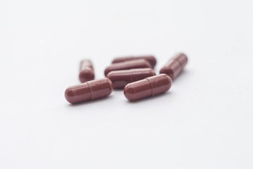 Brown pills on a white background