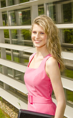 Young bussines woman with modern office in her background