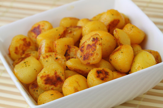 Fried baby potatoes with spices, close up