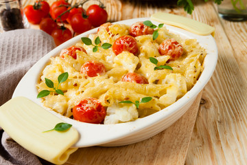 penne under the grated cheese with cherry tomatoes