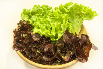 Bowl with two types of salad on white background