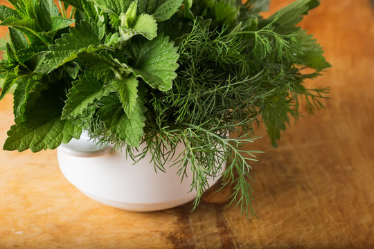 Fresh organic herbs on wooden table