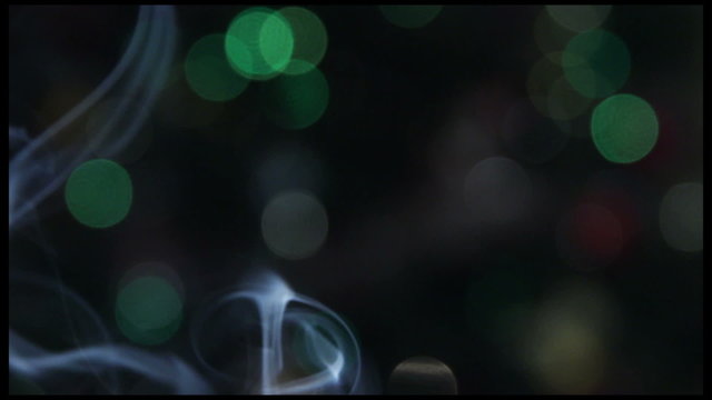 Smoke (fume, reek) & the Christmas Tree Lights background.