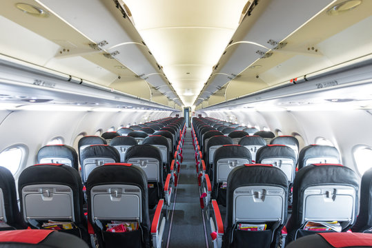 Vanishing Row Of Black And Red Seats In Airplane.