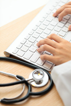 Doctor Typing On Keyboard With Stethoscope