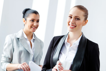 Two attractive business women smiling