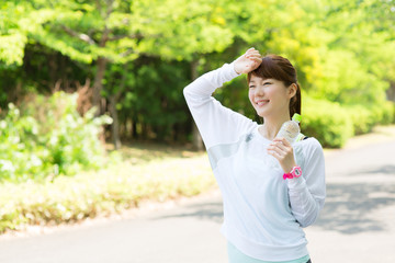 Beautiful asian woman after sport workout in the park