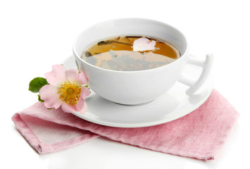 Cup of herbal tea with hip rose flowers, isolated on white