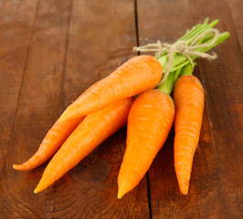 Heap of carrots on wooden background